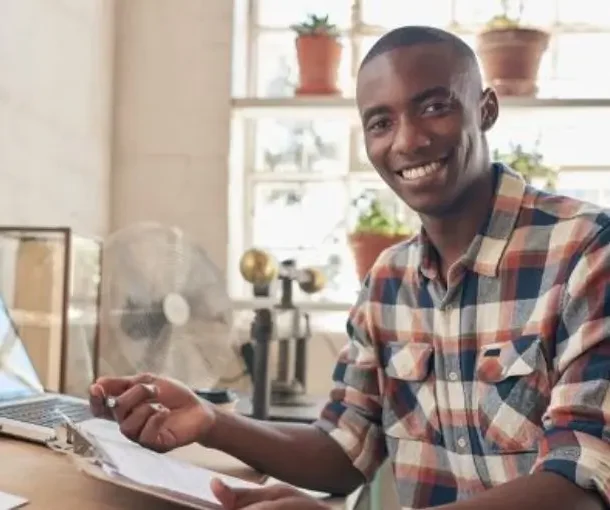 A business owner holding a paper that reads 5 Components of a business plan