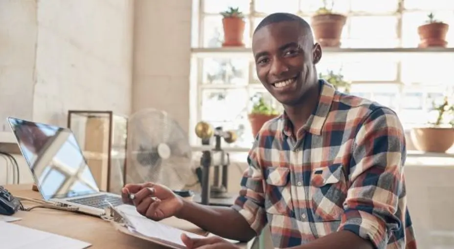 A business owner holding a paper that reads 5 Components of a business plan