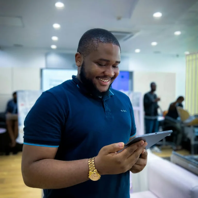 small Business owner looking at his tablet smiling